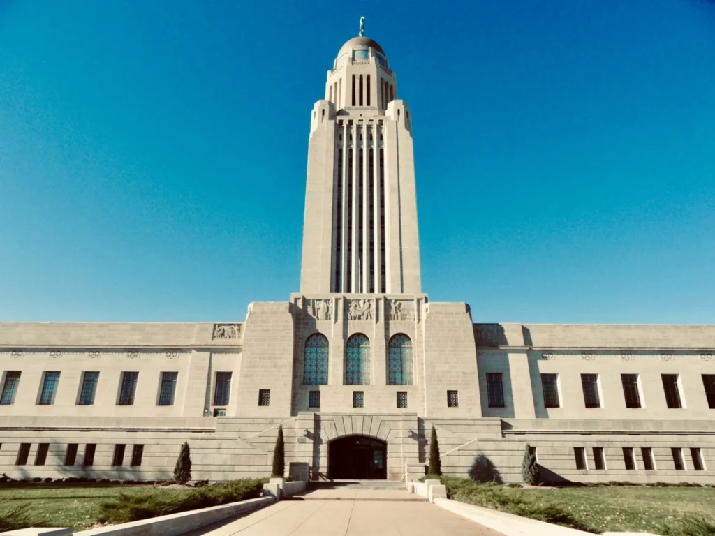The iconic Nebraska State Capitol building in Lincoln, the administrative hub for Nebraska corporate tax rate, featuring a flat 5.2% rate for 2026."