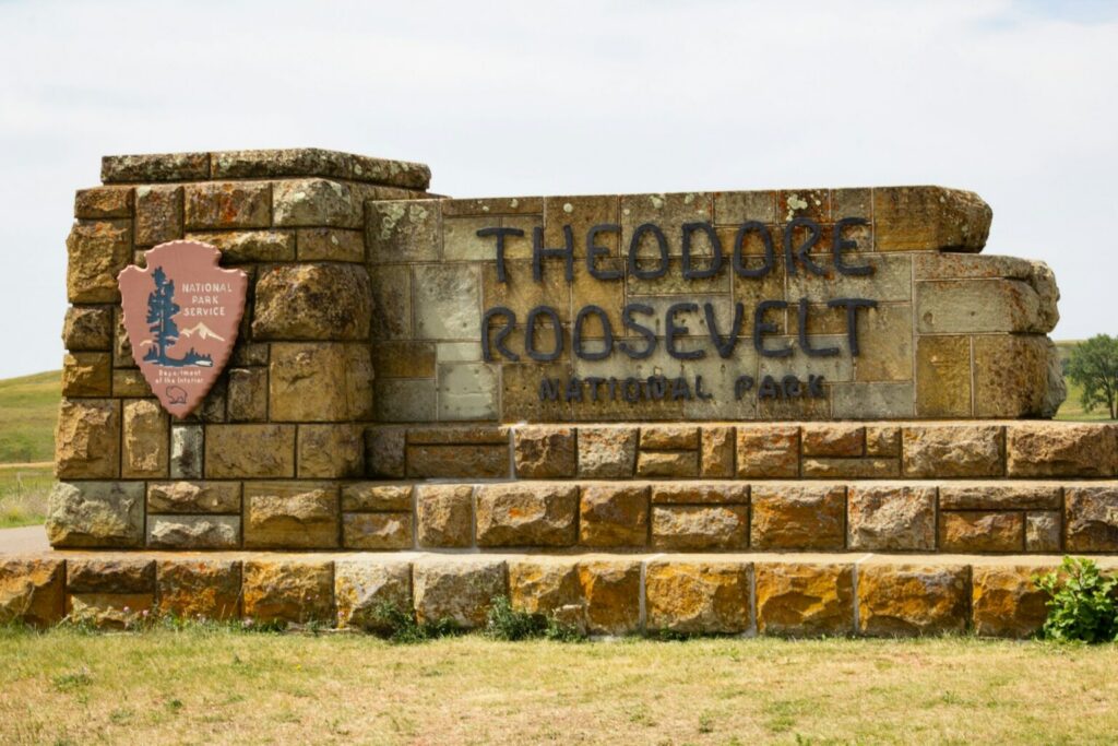A stone sign that reads Theodore Roosevelt National Park